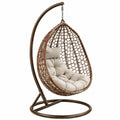 Sedia a dondolo sospesa in rattan sintetico con cuscini beige e struttura in metallo